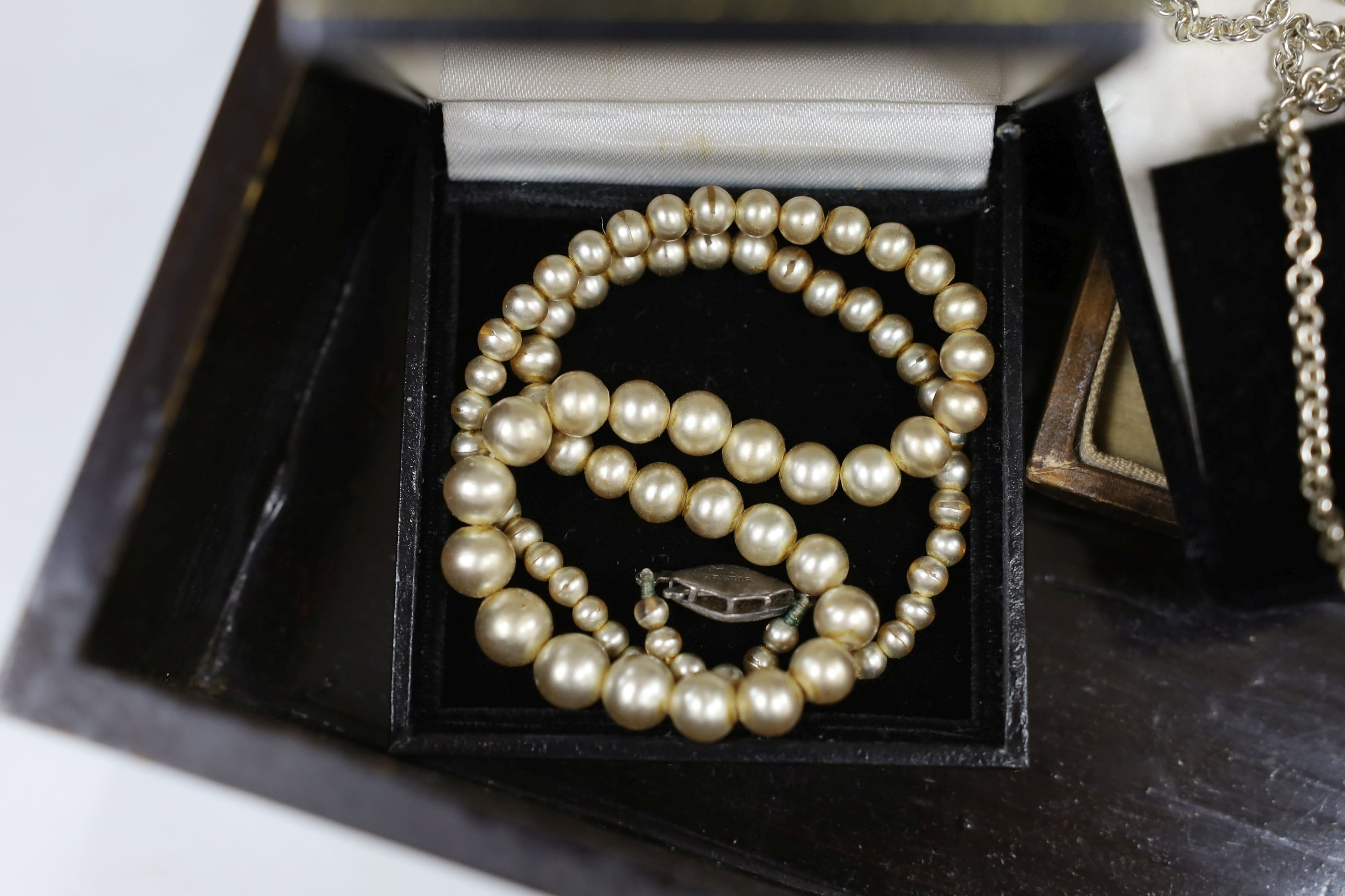 Assorted jewellery including costume, a silver brooch, an engraved yellow metal heart shaped locket, micro mosaic brooch etc. housed in an inlaid box.